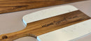 White marble cutting board with wooden handle and 'Home Sweet Home' engraving on a neutral background